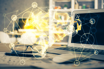 Double exposure of table with computer and brain hologram. Data innovation concept.