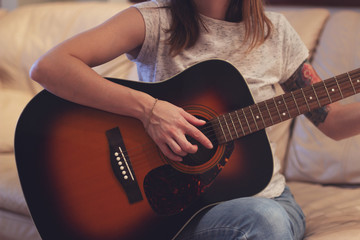young tattooed woman with guitar