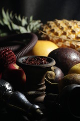 bowl with tobacco for hookah. fruits on a dark background. smoking hookah
