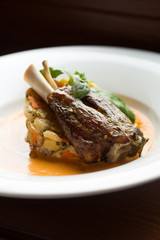 Baked meat on the bone with vegetables