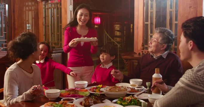 Happy family eating dinner for Chinese New Year,4K