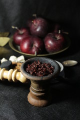 bowl with tobacco for hookah. fruits on a dark background. smoking nargile