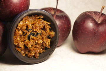 bowl with tobacco for hookah. fruits on a white background. smoking nargile