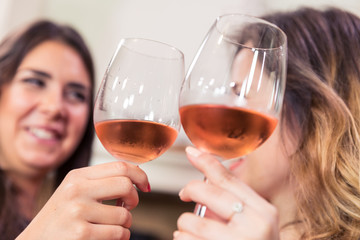 Close-up of friends toasting with wine.