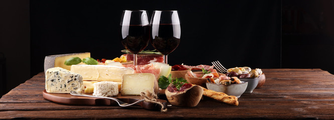 Italian antipasti wine snacks set. Cheese variety, Mediterranean olives, seafood salad, Prosciutto...