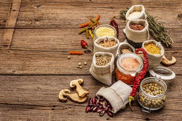 Zero waste food shopping concept. Cereals, pasta, legumes, dried mushrooms, spices. Sustainable lifestyle, old wooden boards background