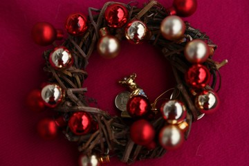 New Year 's attribute - gift wreath of branches with balls gold and red and rat figure