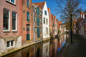 Fototapeta na wymiar Traditional dutch brick houses at the Alkmaar canal