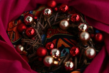 New Year 's wreath of branches and gold and red balls on beige background