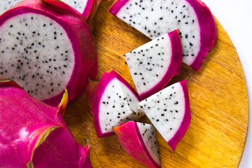 dragon fruit sliced rings on a wooden cutting board, tropical dessert
