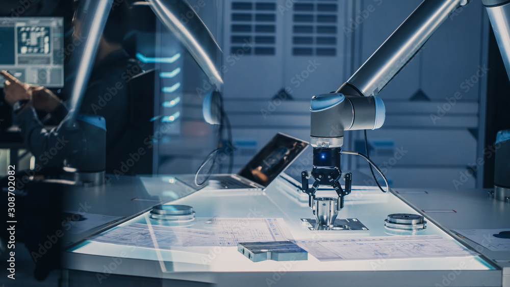 Poster futuristic artificial intelligence robotic arm operates and moves a metal object, picks it up or put