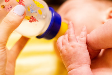 Charming mother feeding her adorable son in the kitchen at home