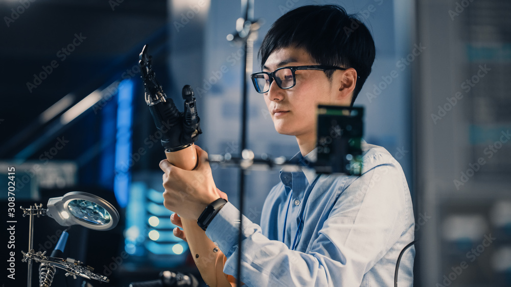 Aufkleber futuristic prosthetic robot arm being tested by a professional japanese development engineer in a hi