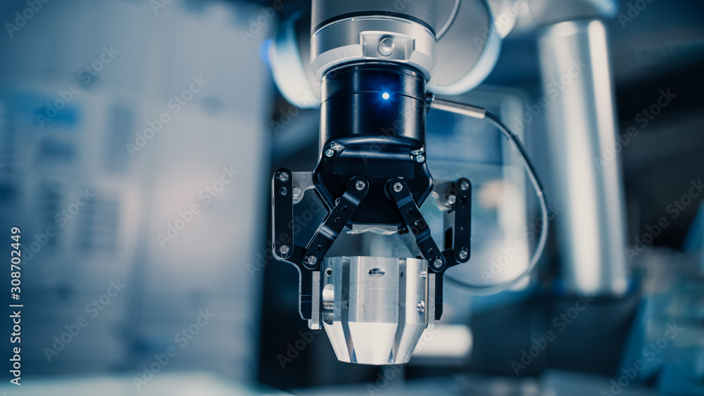 Poster Close Up of a Futuristic Robotic Arm Moving a Metal Object and Placing It. Team of Engineers Observe This Advanced Process. They are in a High Tech Research Laboratory with Modern Equipment.