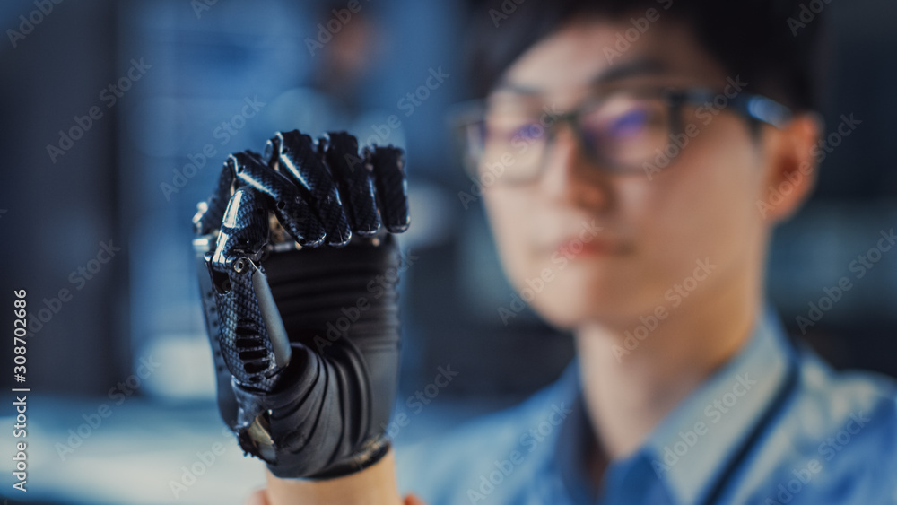 Poster Close Up of a Futuristic Prosthetic Robot Arm Being Tested by a Professional Development Engineer in a High Tech Research Laboratory with Modern Computer Equipment.