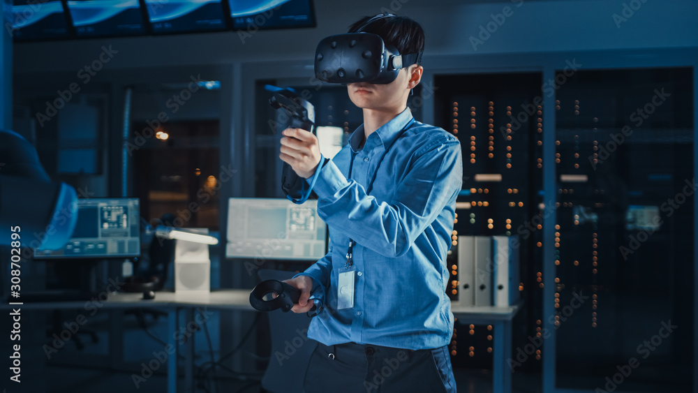 Poster professional japanese development engineer in blue shirt is using augmented reality headset and joys