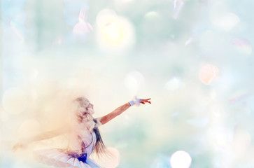 Magical fantasy photo of a girl in a white bundle of ballerinas in the soft light of bokeh and smoke.