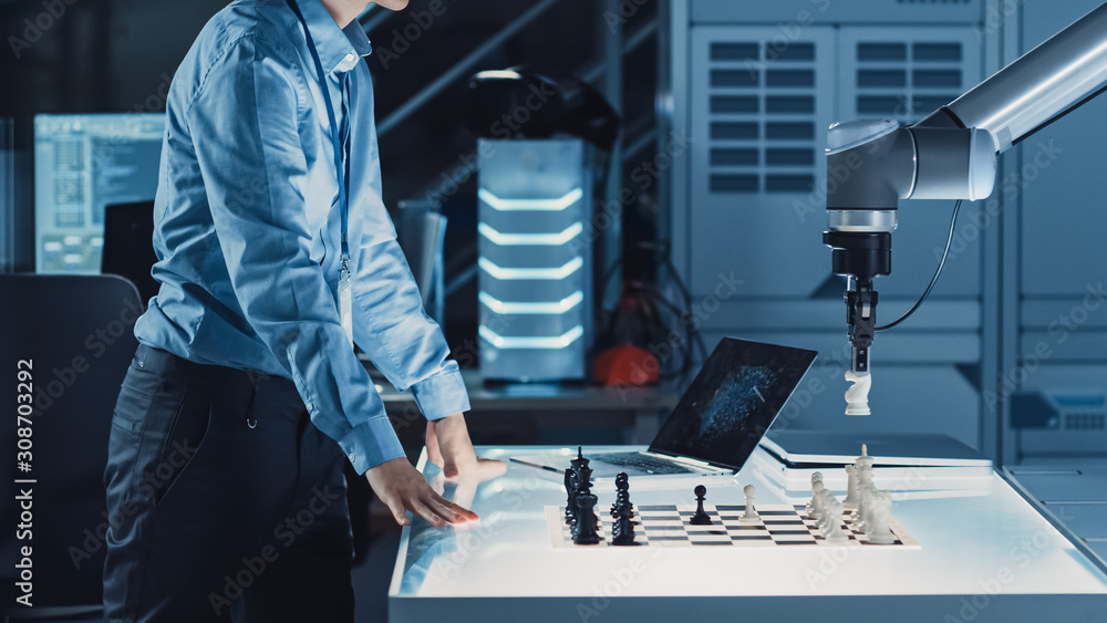 Poster Professional Japanese Development Engineer is Testing an Artificial Intelligence Interface by Playing Chess with a Futuristic Robotic Arm. They are in a High Tech Modern Research Laboratory.
