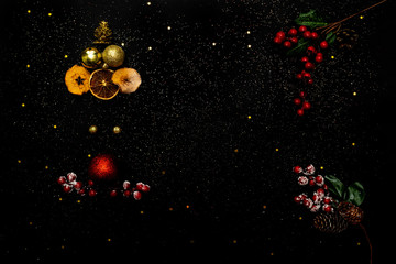 Fototapeta na wymiar Santa Claus from new-year baubles on black with red berries. Black background decorated with stars confetti. Flat lay, top view, place for text. Christmas concept.