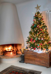 Christmas tree with burning log fire in the background. Stock image