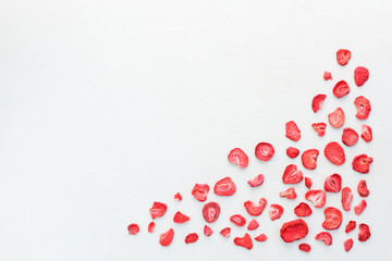 Sliced sublimated strawberries on a white background.