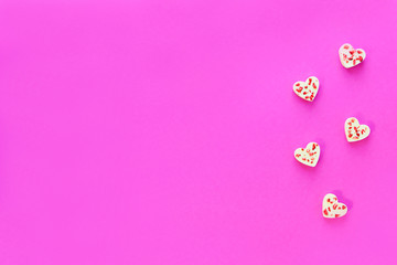 Candy hearts made of white chocolate and sublimated strawberries on a pink background. Valentine's Day.