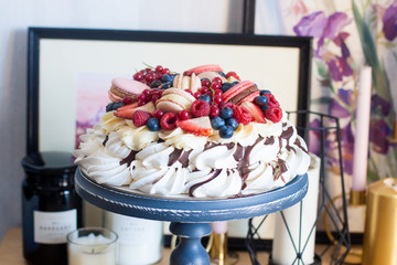 Whipped meringue cake with cream cheese, melted chocolate and fresh berries, strawberries,...
