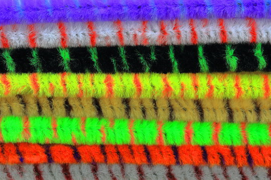 A close up color image of pipe cleaners of multiple colors.