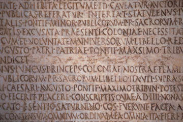 Latin inscriptions carved on a stone tablet, background. Texture.