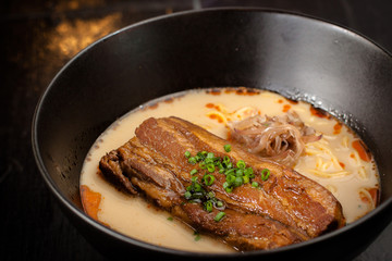 ramen noodle with big roasted pork in creamy soup