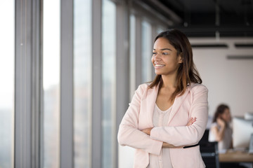 Smiling African American businesswoman standing in office, business vision