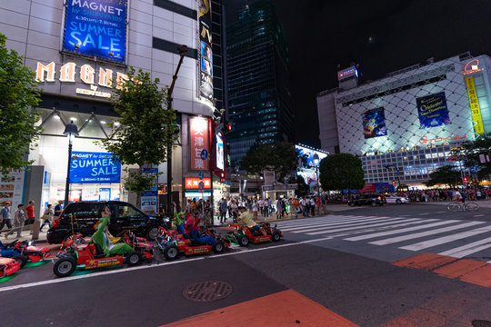 TOKYO JAPAN - AUGUST 26, 2018 : Shibuya crossing, night time. Entertainment for tourists-go-karting tour through the night streets of Tokyo.