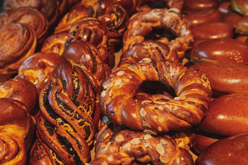 Delicious fresh baked buns. Bakery products with different filling, almond, cream and poppy. Pastry with poppy.