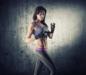 Sexy and fit brunette woman preparing for training