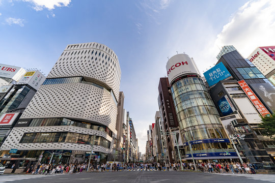 JAPAN, TOKYO, Ginza – August 2018: Landmark of Ginza. Ricoh’s Ginza Electronic Billboard. Pedestrian crossing the street. Pedestrian Heaven. Shopping at Ginza, Tokyo. Wide Angle HDR Shot.