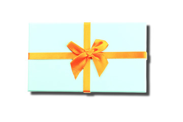Christmas gift box blue. Orange ribbon. White background. Shadow. Top view.