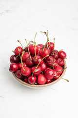 Fresh Red Cherries In A Small Round Stoneware Bowl