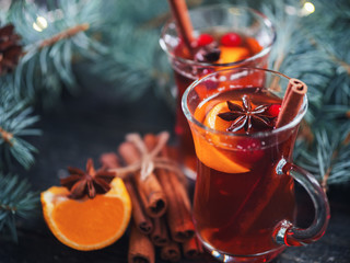 Winter hot drink Christmas mulled wine in glasses with anise, cinnamon and tangerine