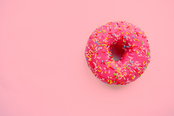 Pink round donut at bright pink background. Sweet donuts.  Trendy sunlight Summer pattern Minimal summer concept.