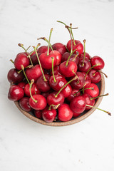Naklejka na ściany i meble Fresh Red Cherries In A Small Round Stoneware Bowl