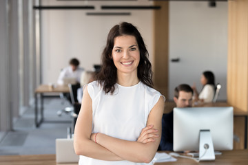 Head shot portrait of successful smiling businesswoman in office