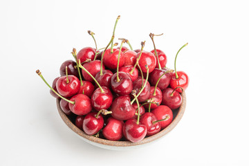 Fototapeta na wymiar Fresh Red Cherries In A Small Round Stoneware Bowl