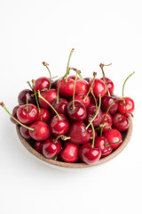 Obraz na płótnie Canvas Fresh Red Cherries In A Small Round Stoneware Bowl