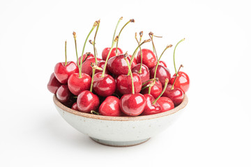 Fresh Red Cherries In A Small Round Stoneware Bowl