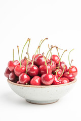 Fresh Red Cherries In A Small Round Stoneware Bowl