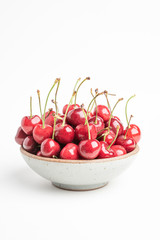 Fresh Red Cherries In A Small Round Stoneware Bowl