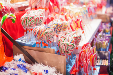Display on a Christmas candy market stall. Holidays street market, confectionery shop