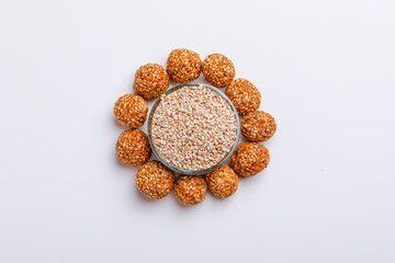 Til Gul OR Sweet Sesame Laddu for Indian festival Makar Sankranti over white background 