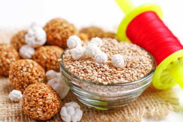 Til Gul OR Sweet Sesame Laddu with Fikri for Indian festival Makar Sankranti over white background 