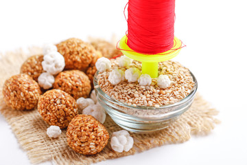 Til Gul OR Sweet Sesame Laddu with Fikri for Indian festival Makar Sankranti over white background 